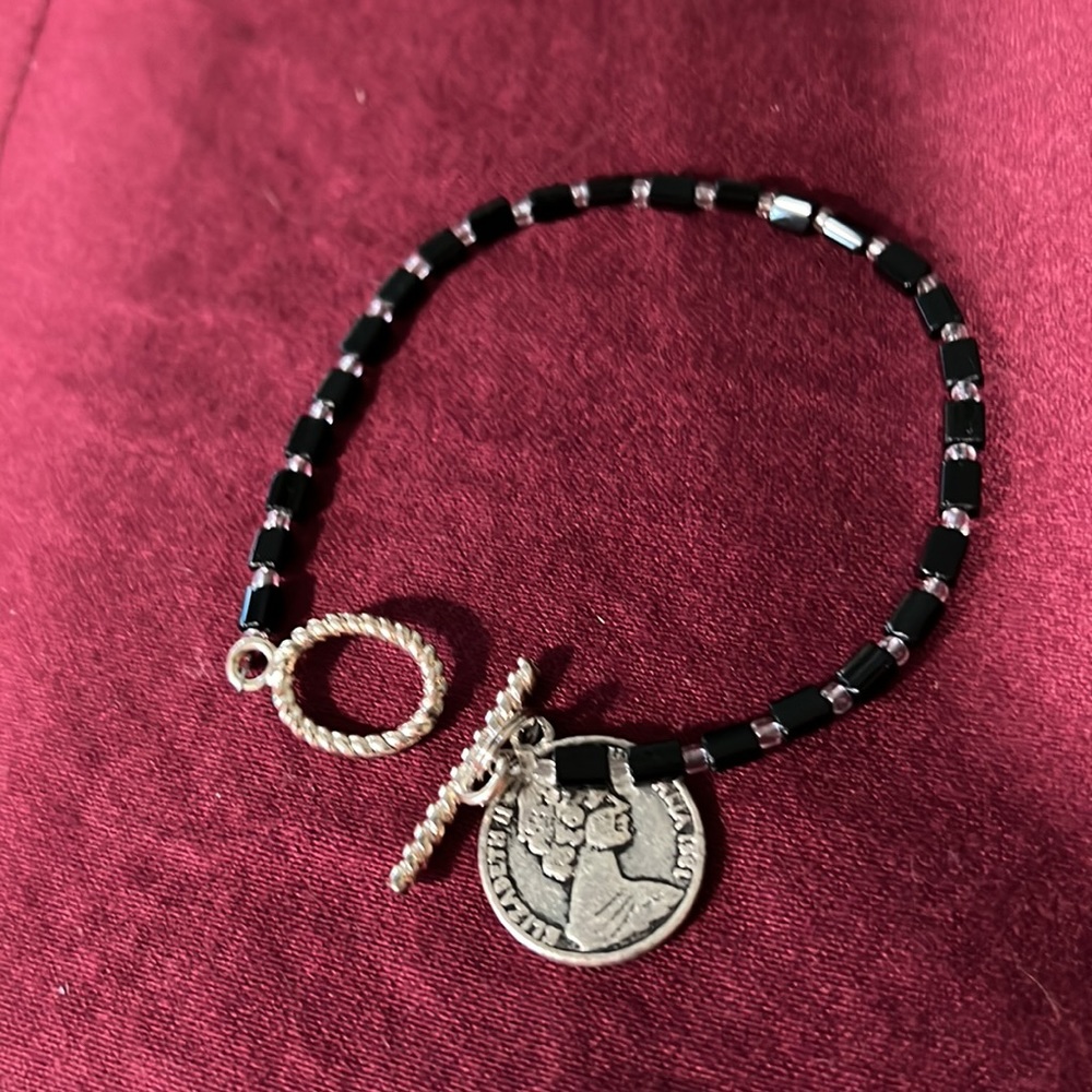 Glass beaded bracelet with silver tone, clear glass /black glass beads/coin